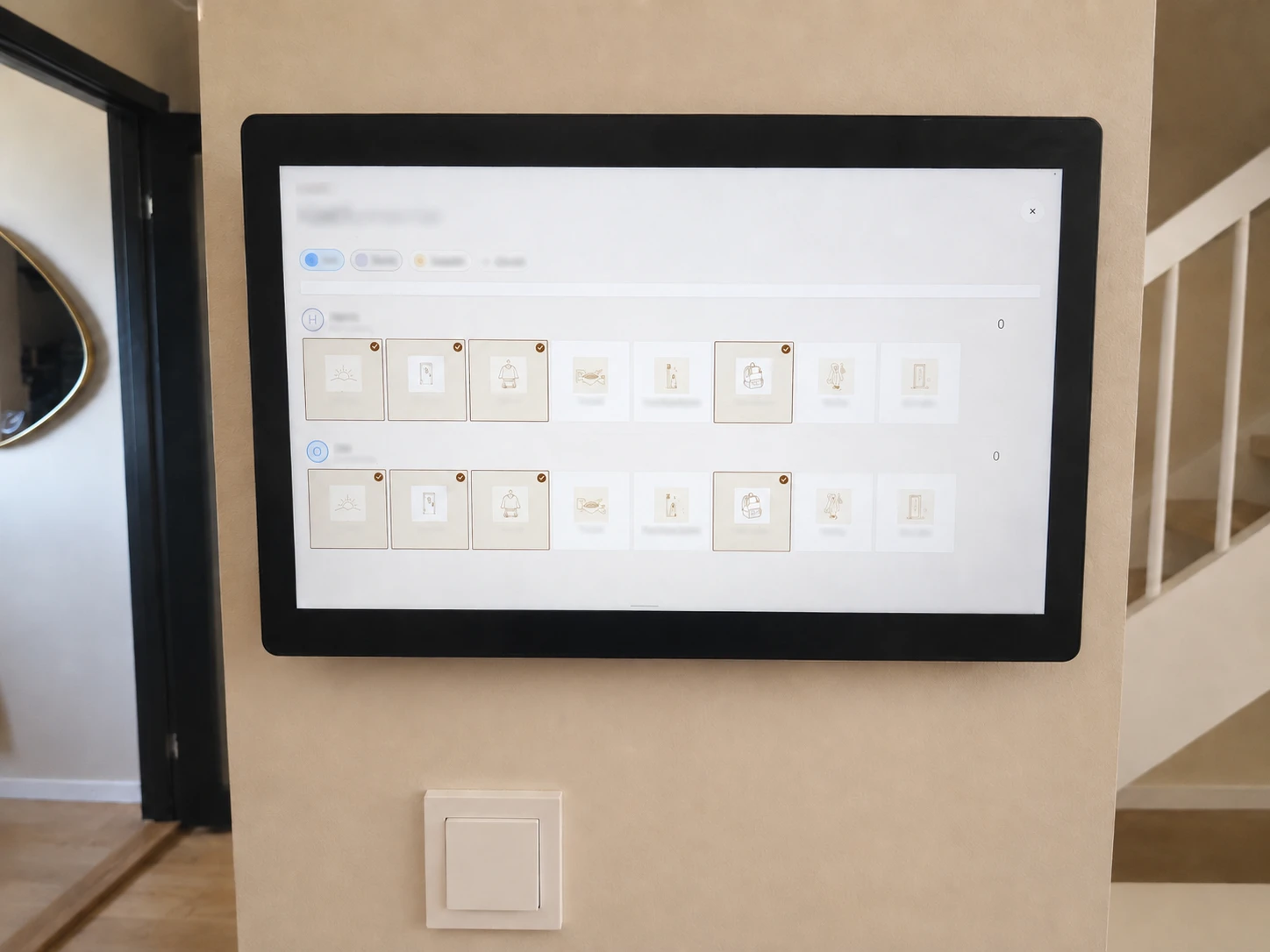 Wall-mounted Zenframe display showing a household routine grid in a hallway